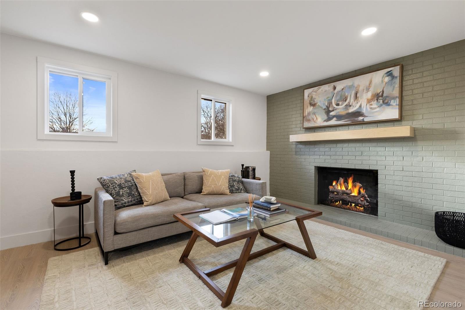 9458 Flower Street Broomfield, CO 80021 - Photo 13 of 30 a living room with furniture and a fireplace