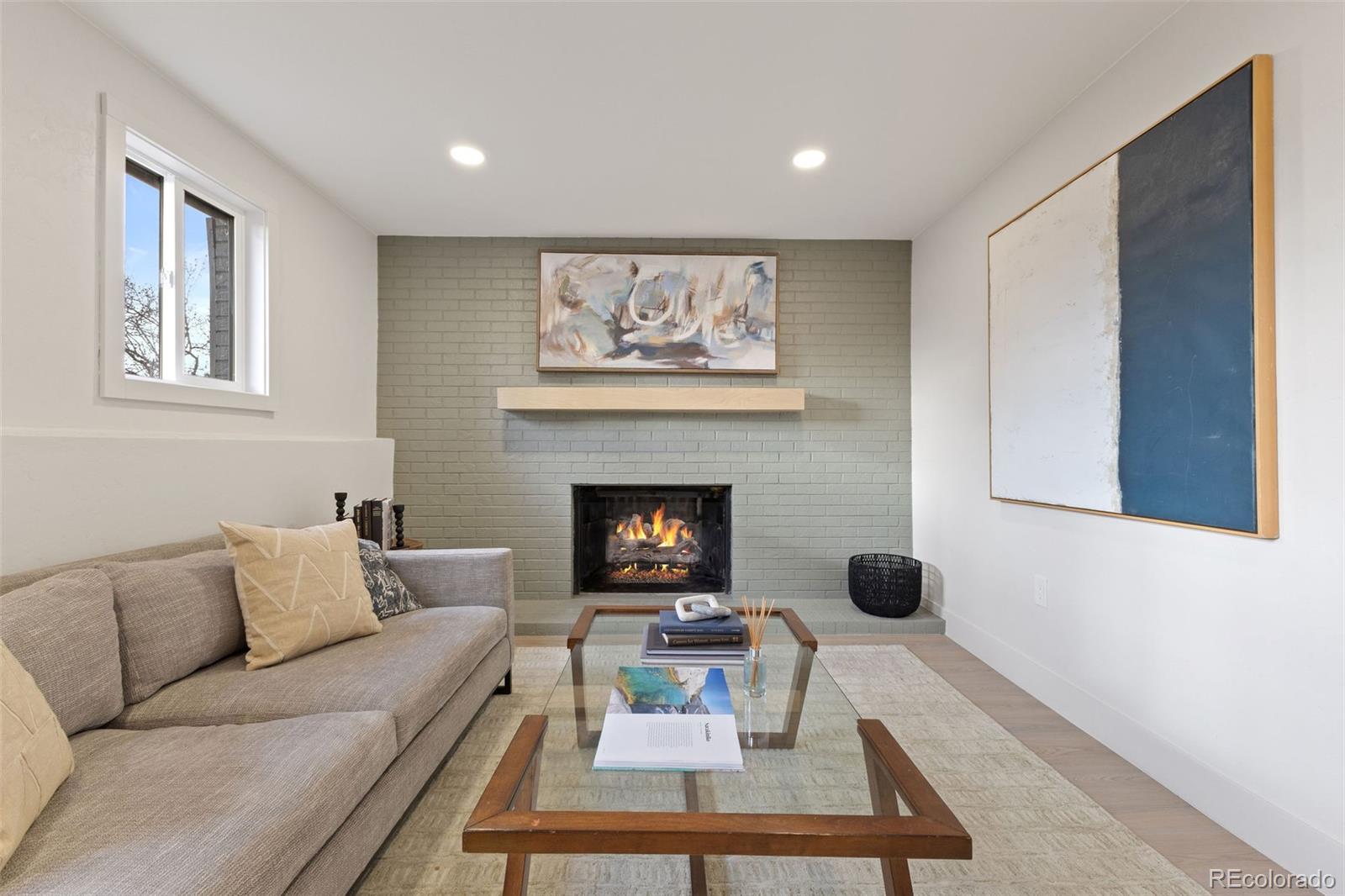 9458 Flower Street Broomfield, CO 80021 - Photo 14 of 30 a living room with furniture and a fireplace