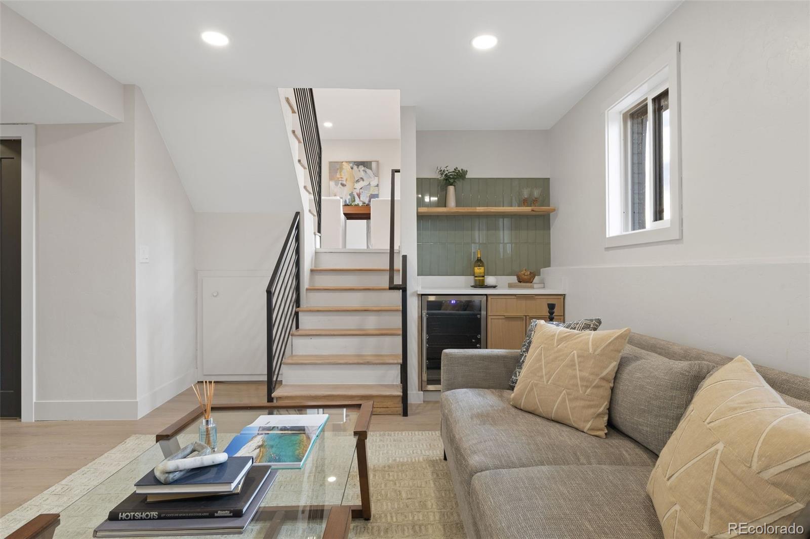 9458 Flower Street Broomfield, CO 80021 - Photo 16 of 30 a living room with furniture and a chandelier