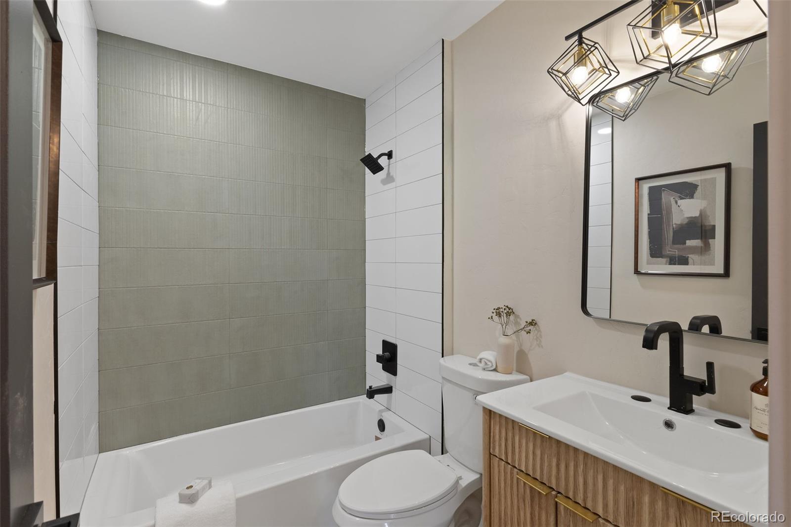 9458 Flower Street Broomfield, CO 80021 - Photo 19 of 30 a bathroom with a sink a toilet and shower