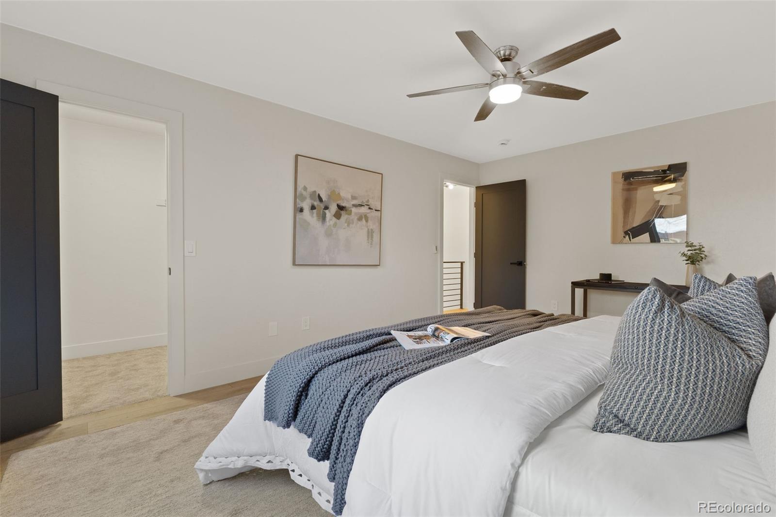 9458 Flower Street Broomfield, CO 80021 - Photo 20 of 30 a bedroom with a bed and a painting on the wall