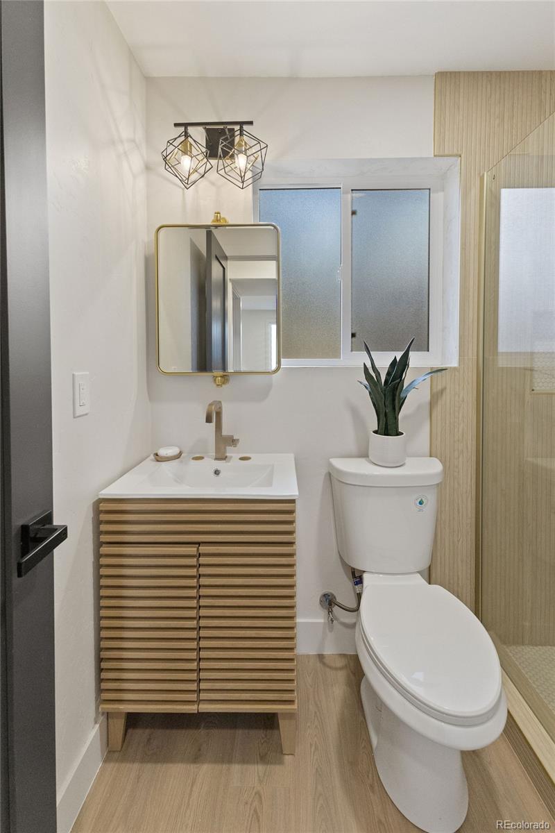 9458 Flower Street Broomfield, CO 80021 - Photo 21 of 30 a bathroom with a sink a toilet and mirror