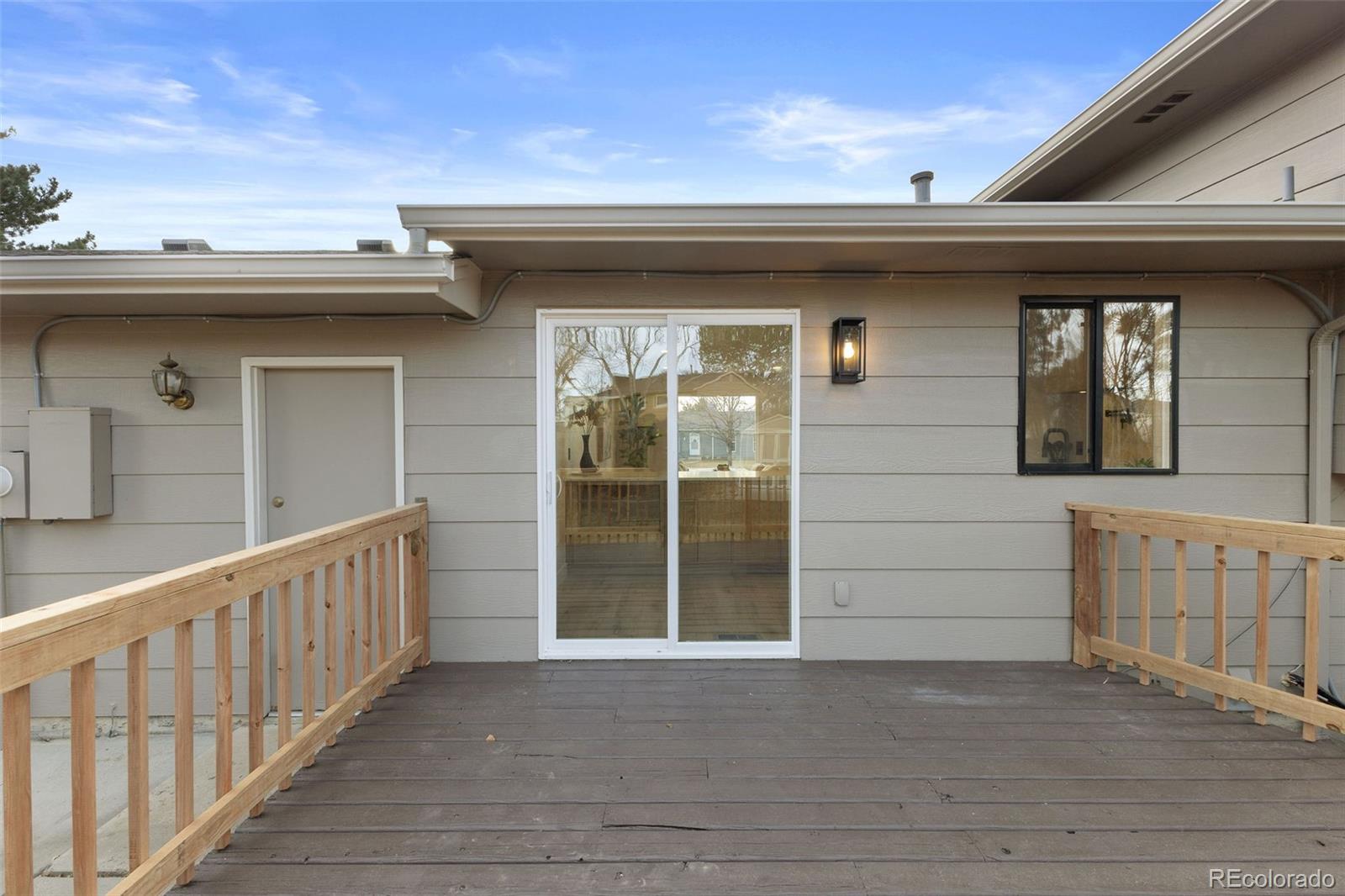 9458 Flower Street Broomfield, CO 80021 - Photo 27 of 30 a view of a house with a wooden deck