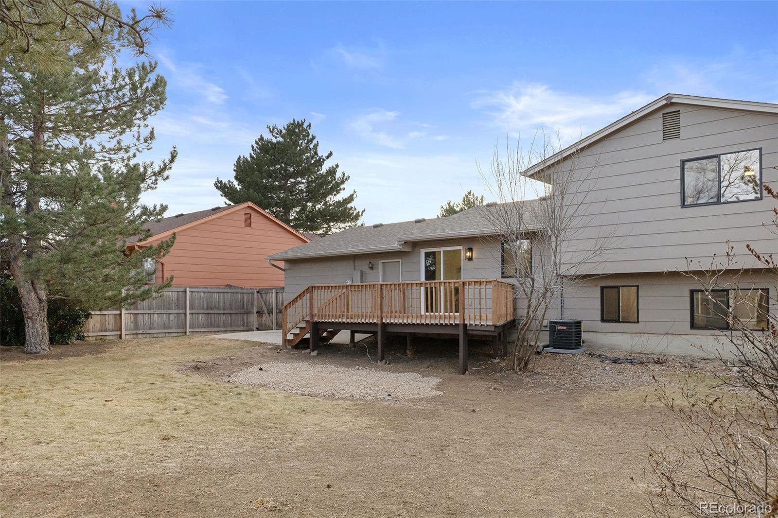 9458 Flower Street Broomfield, CO 80021 - Photo 29 of 30 a view of a house with a yard and roof