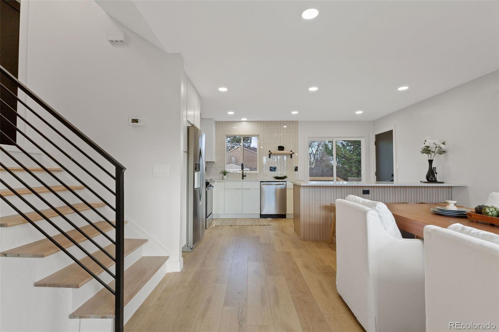 9458 Flower Street Broomfield, CO 80021 - Photo 3 of 30 a view of kitchen with furniture and refrigerator