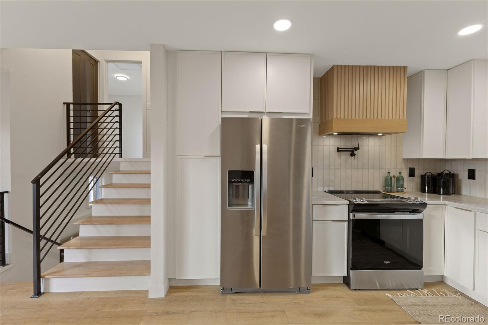 9458 Flower Street Broomfield, CO 80021 - Photo 7 of 30 a kitchen with cabinets and stainless steel appliances
