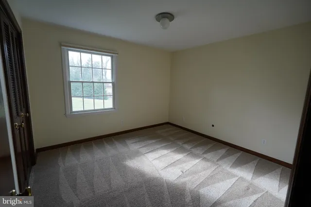 a bathroom with a granite countertop sink toilet and a mirror