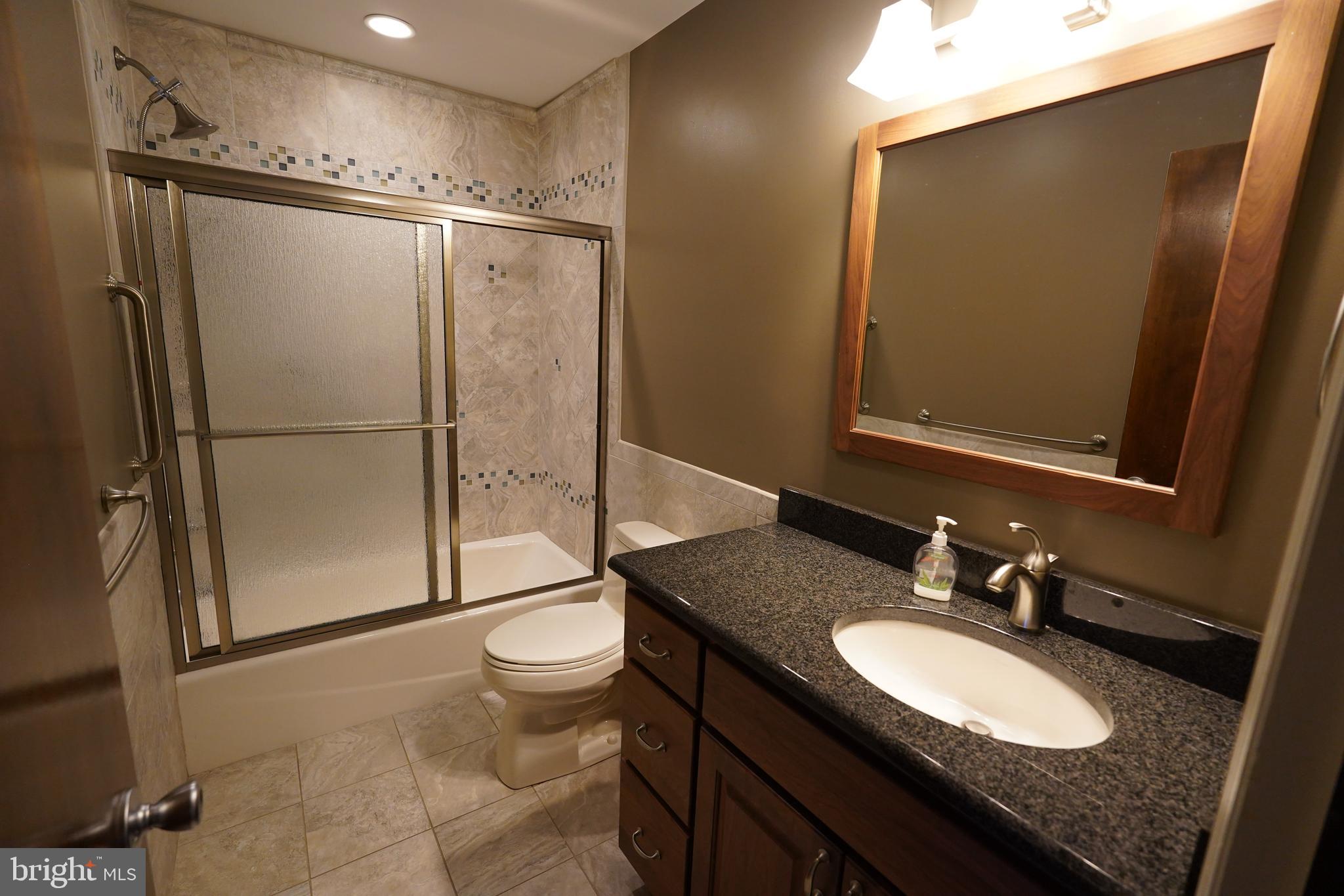 212 Seneca Circle State College, PA 16801 - Photo 15 of 67 a bathroom with a granite countertop sink toilet and a mirror