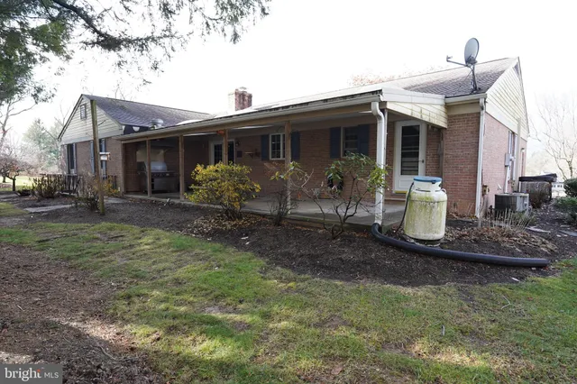 a kitchen with stainless steel appliances granite countertop a refrigerator a sink dishwasher a stove and white countertops with wooden floor