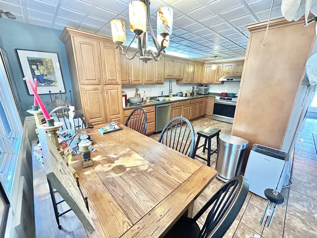 700 2nd Street, Unit 105 Fall River, MA 02721 - Photo 8 of 16 a view of a dining room with furniture window and wooden floor