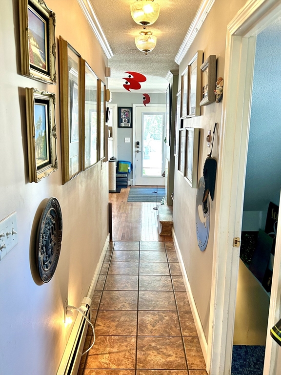 700 2nd Street, Unit 105 Fall River, MA 02721 - Photo 9 of 16 a view of a hallway with a dining table & chairs