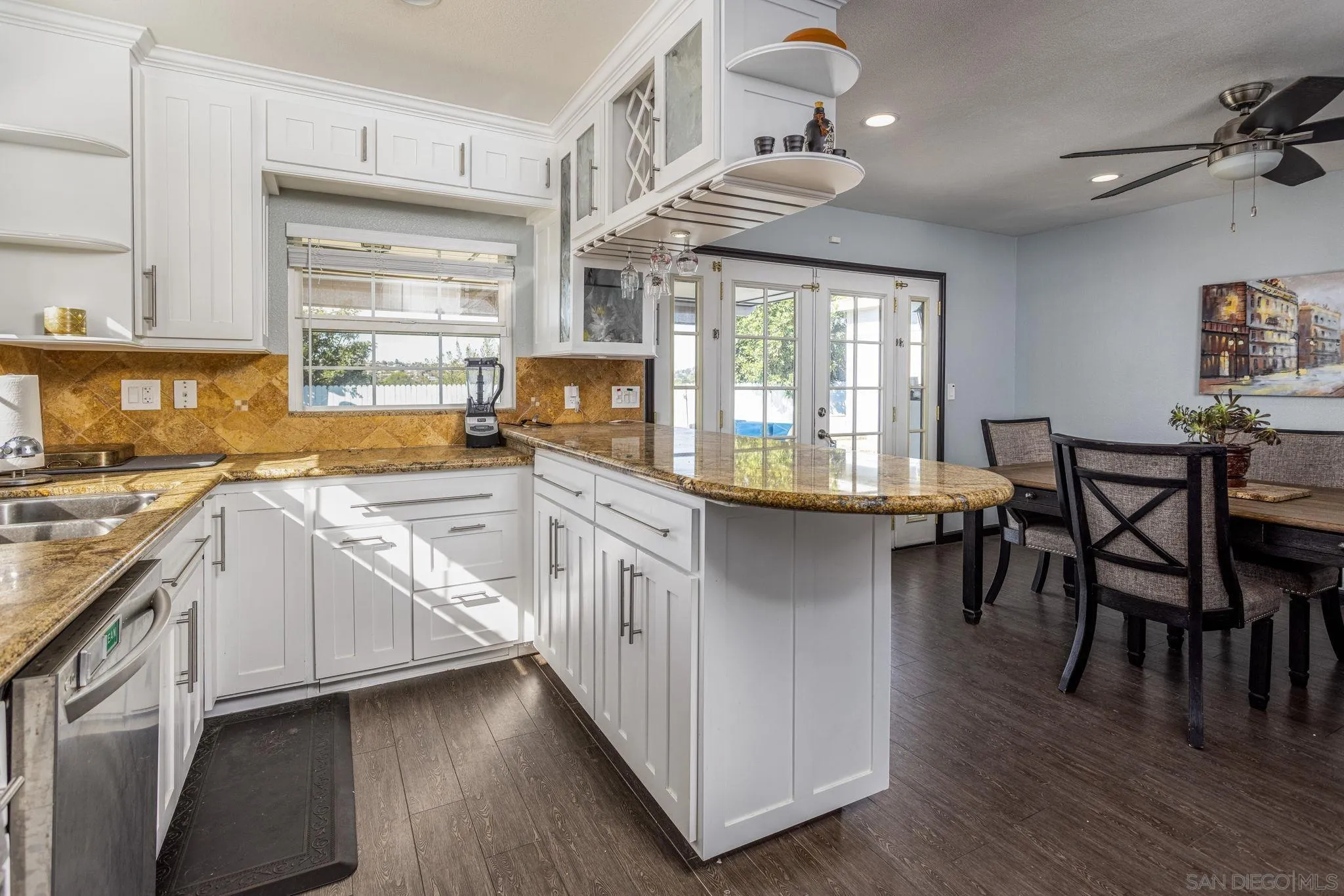 532 Kempton Street Spring Valley, CA 91977 - Photo 10 of 30 a kitchen with stainless steel appliances granite countertop a stove and a wooden floors