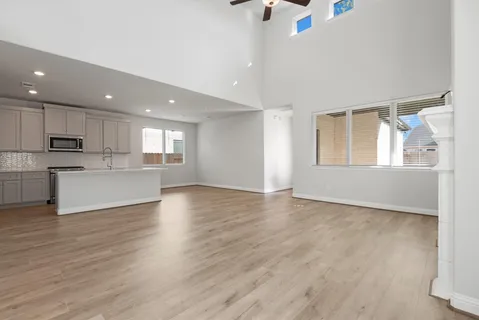 a kitchen with granite countertop white cabinets and a window