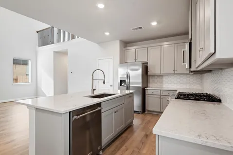 a kitchen with a sink and a refrigerator