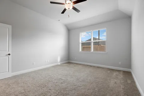 a view of an empty room with a ceiling fan