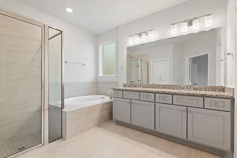 a bathroom with a bathtub and shower