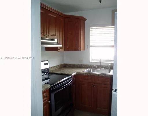 a kitchen with a sink and a window