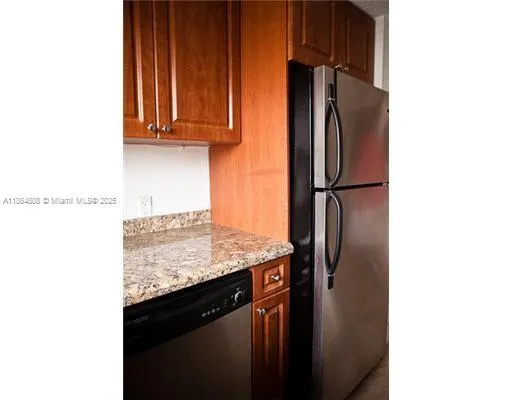 a kitchen with stainless steel appliances granite countertop a refrigerator and a sink