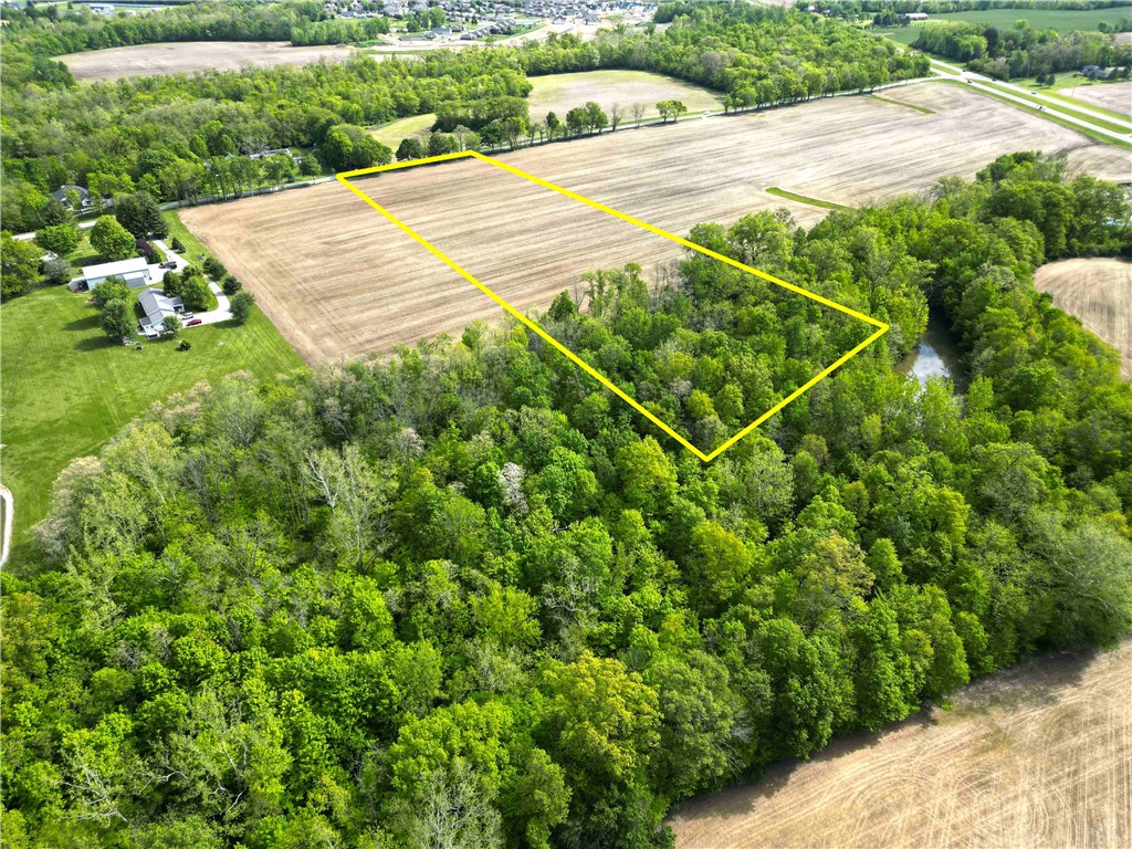 2 Hedges Road Xenia, OH 45385 - Photo 5 of 13 An aerial perspective reveals a serene parcel of land, bordered by mature trees and open fields.