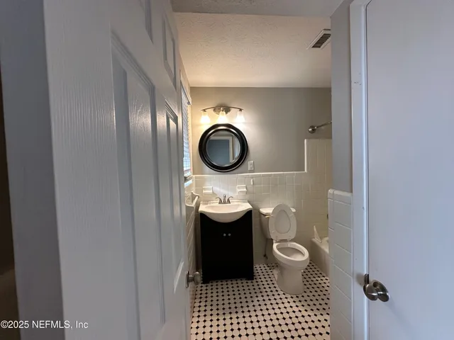 a bathroom with a sink a toilet and bathtub