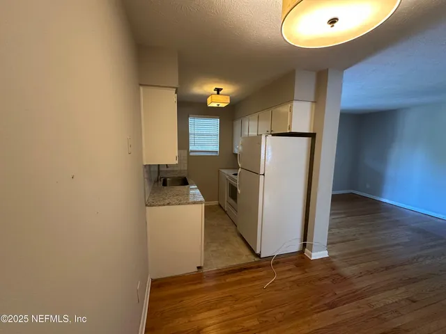 a kitchen with a sink stove and mirror