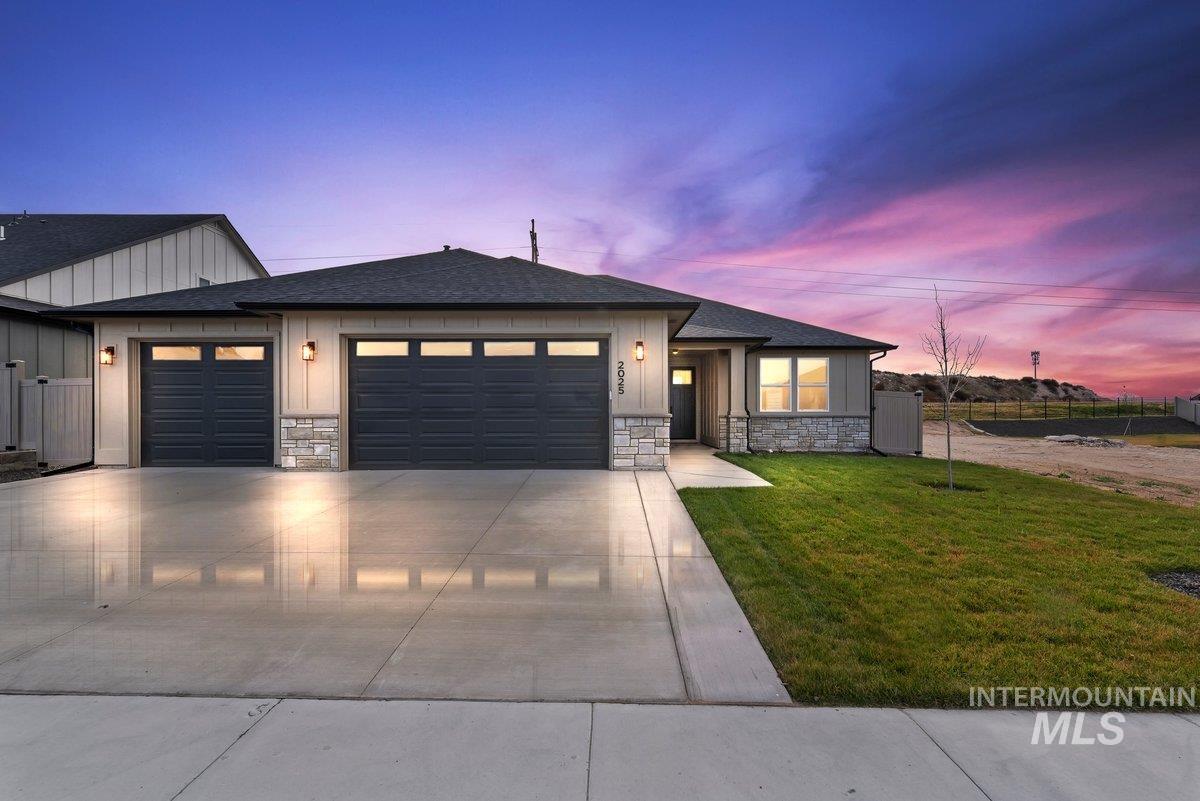 2025 West Bittern Street Nampa, ID 83686 - Photo 1 of 32 View of front of home with stone siding, a shingled roof, a garage, and driveway