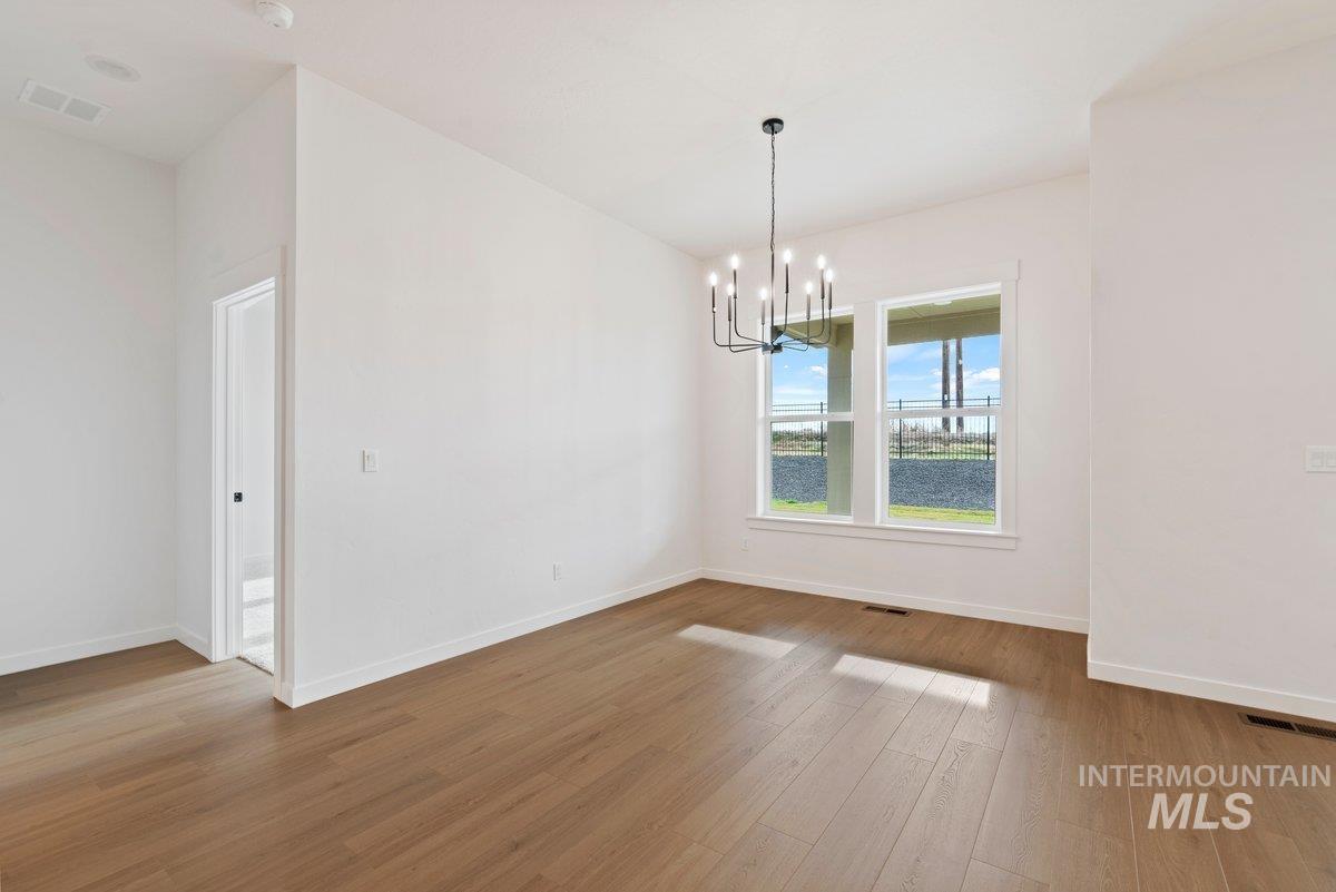2025 West Bittern Street Nampa, ID 83686 - Photo 12 of 32 Unfurnished dining area featuring a chandelier and light wood finished floors