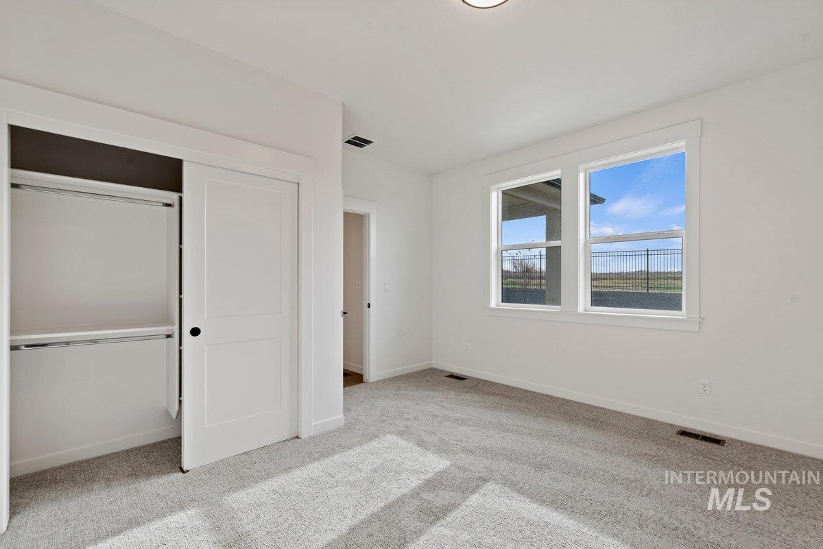 2025 West Bittern Street Nampa, ID 83686 - Photo 20 of 32 Unfurnished bedroom with light colored carpet and a closet