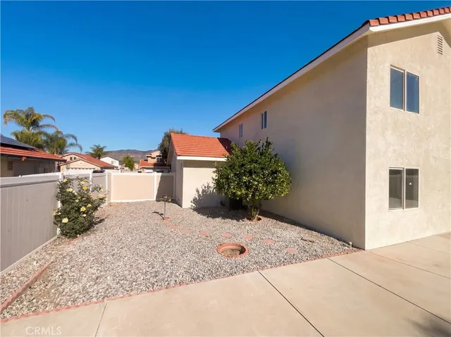 a backyard of a house with potted plants