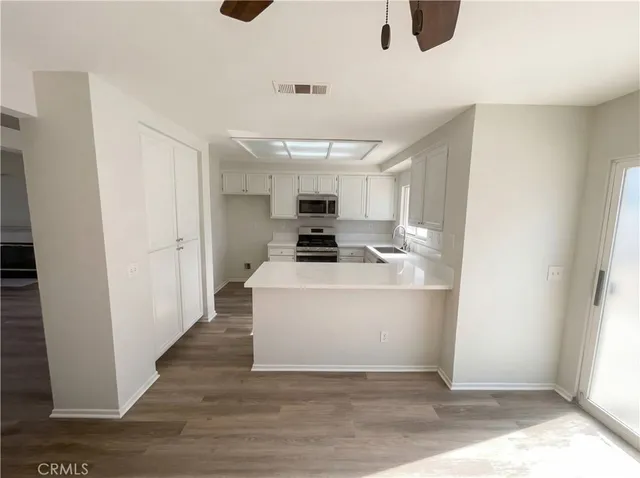 a view of kitchen with furniture wooden floor and window