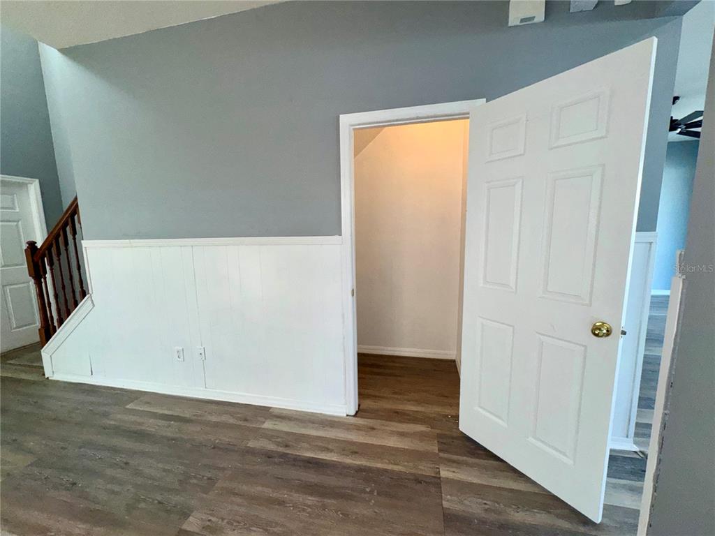 18403 Fish Loop Land O Lakes, FL 34638 - Photo 14 of 64 an empty room with wooden floor and windows
