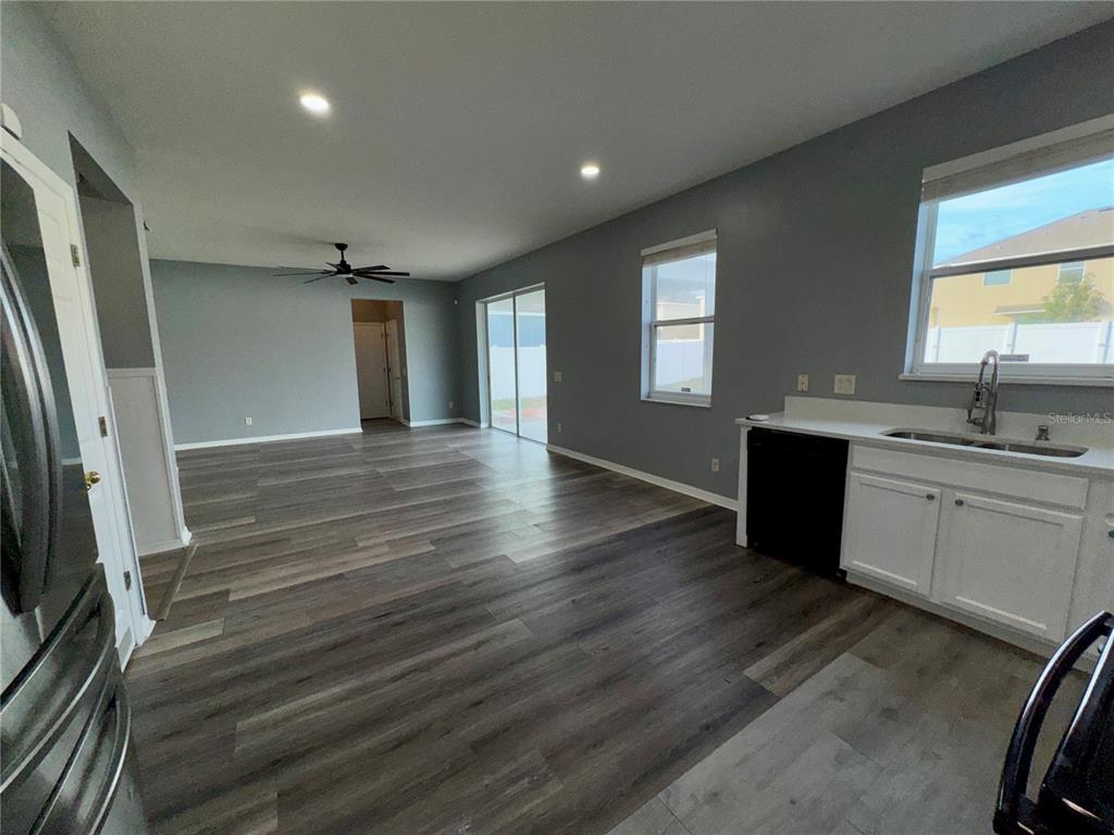 18403 Fish Loop Land O Lakes, FL 34638 - Photo 20 of 64 a view of a kitchen counter space wooden floor and staircase