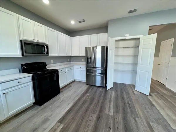 wooden floor in an empty room with a fireplace