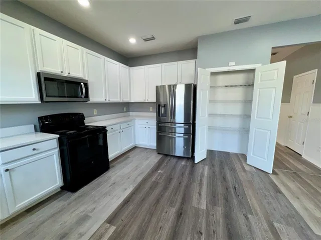 wooden floor in an empty room with a fireplace