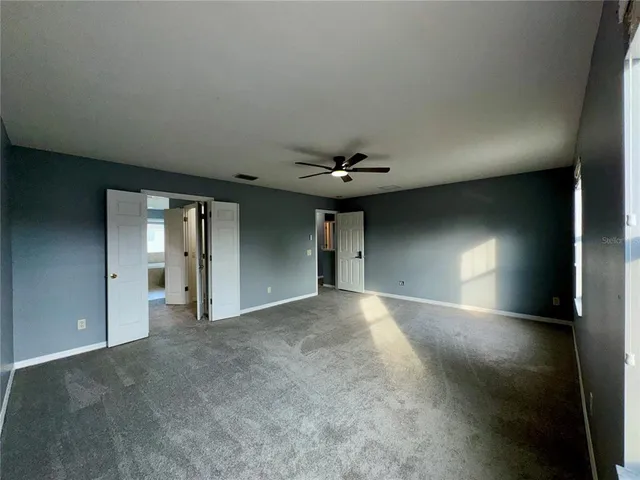 a view of a hallway with closet and wooden floor