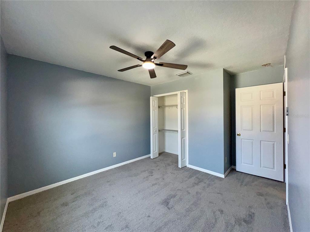 18403 Fish Loop Land O Lakes, FL 34638 - Photo 48 of 64 an empty room with closet and fan