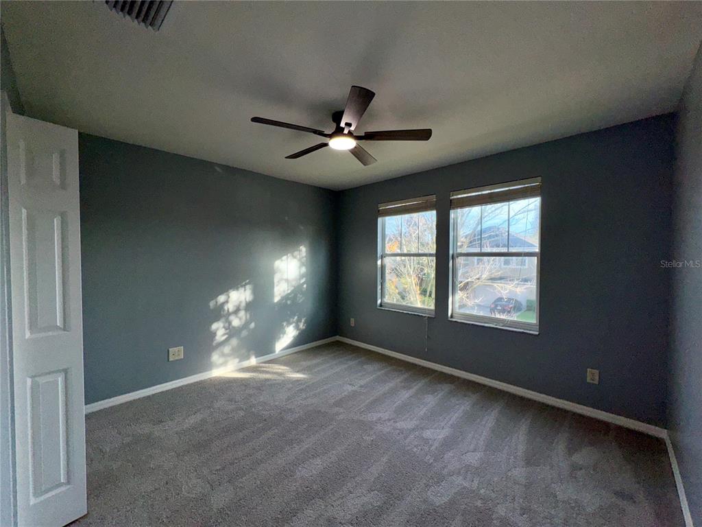 18403 Fish Loop Land O Lakes, FL 34638 - Photo 49 of 64 a view of a livingroom with a ceiling fan and window