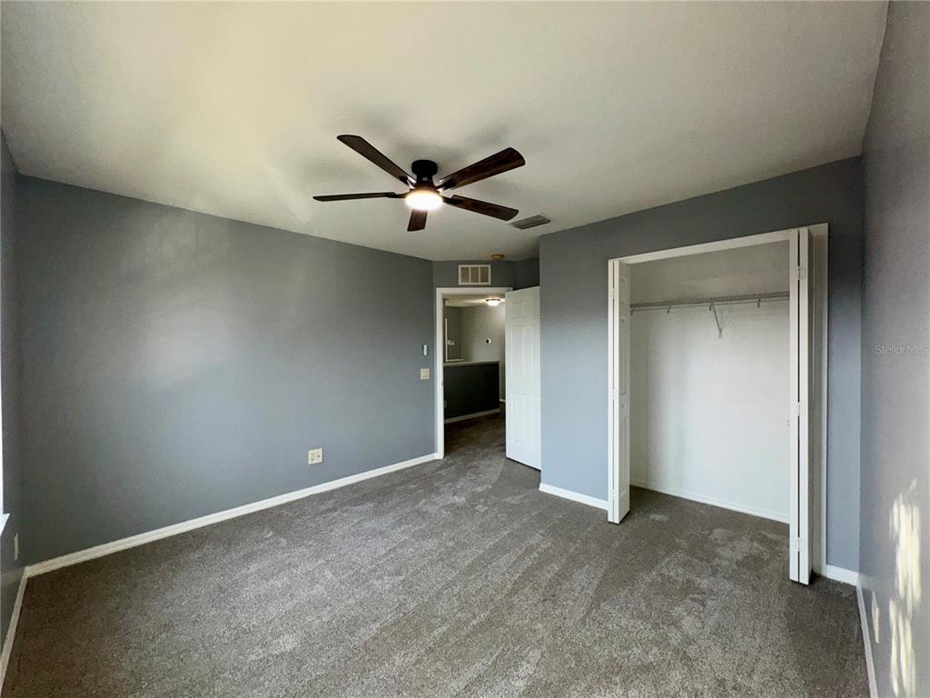 18403 Fish Loop Land O Lakes, FL 34638 - Photo 51 of 64 an empty room with a ceiling fan and window