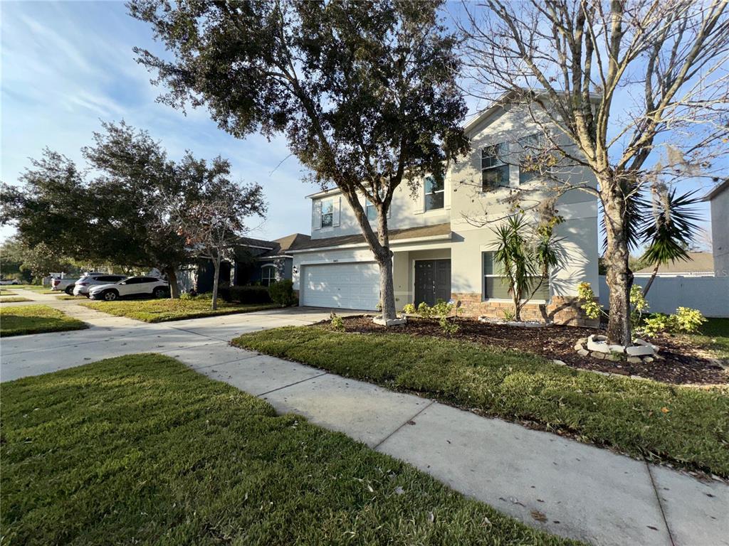 18403 Fish Loop Land O Lakes, FL 34638 - Photo 6 of 64 a front view of a house with garden and porch