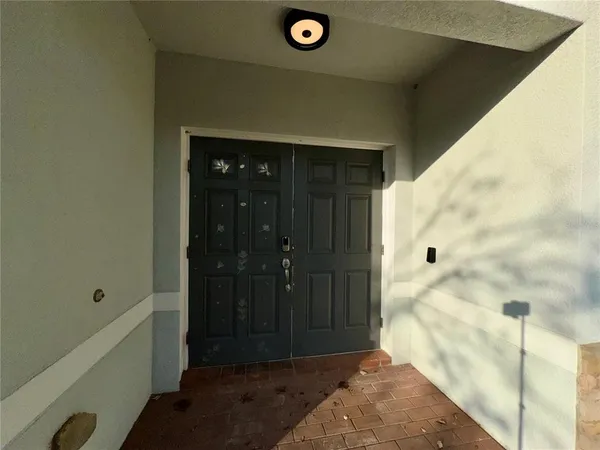 a view of a hallway with wooden floor and entryway