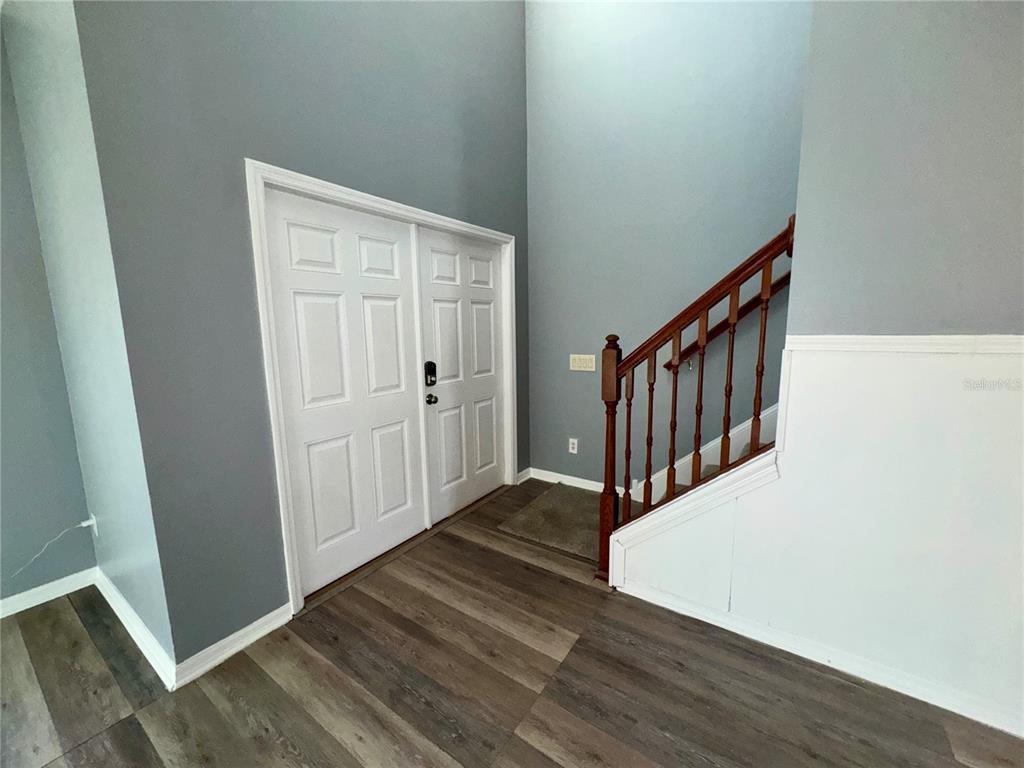 18403 Fish Loop Land O Lakes, FL 34638 - Photo 9 of 64 a view of a hallway with wooden floor and entryway