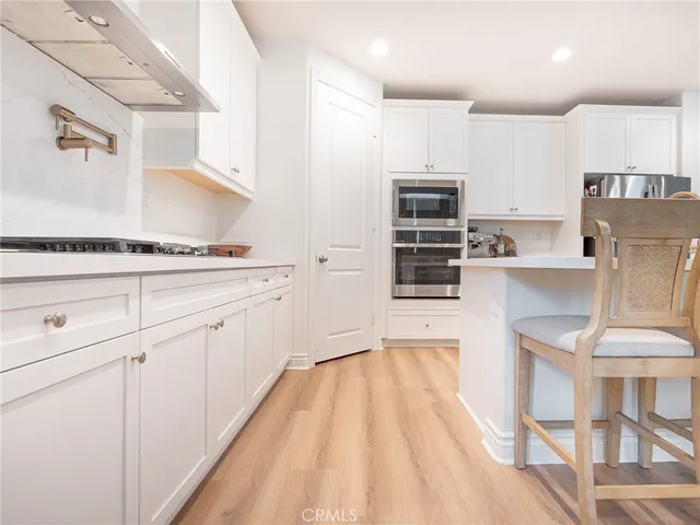 a kitchen with stainless steel appliances a stove a sink and a refrigerator
