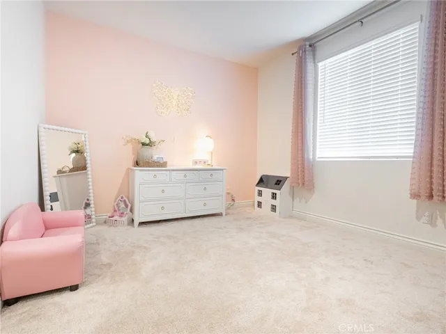 a room with a dresser and a window