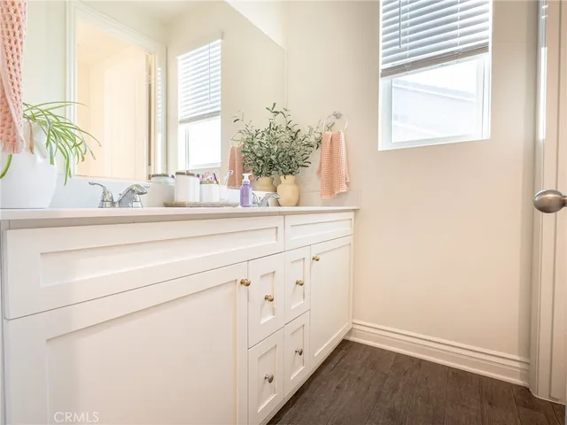 a white toilet sitting in a bathroom next to a sink