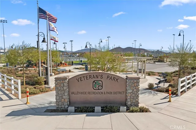 an aerial view of residential houses with outdoor space and ocean view