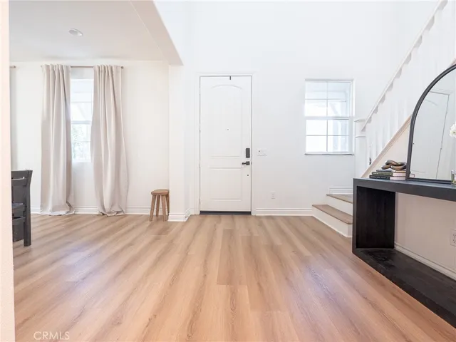 a view of a room with wooden floor and a window