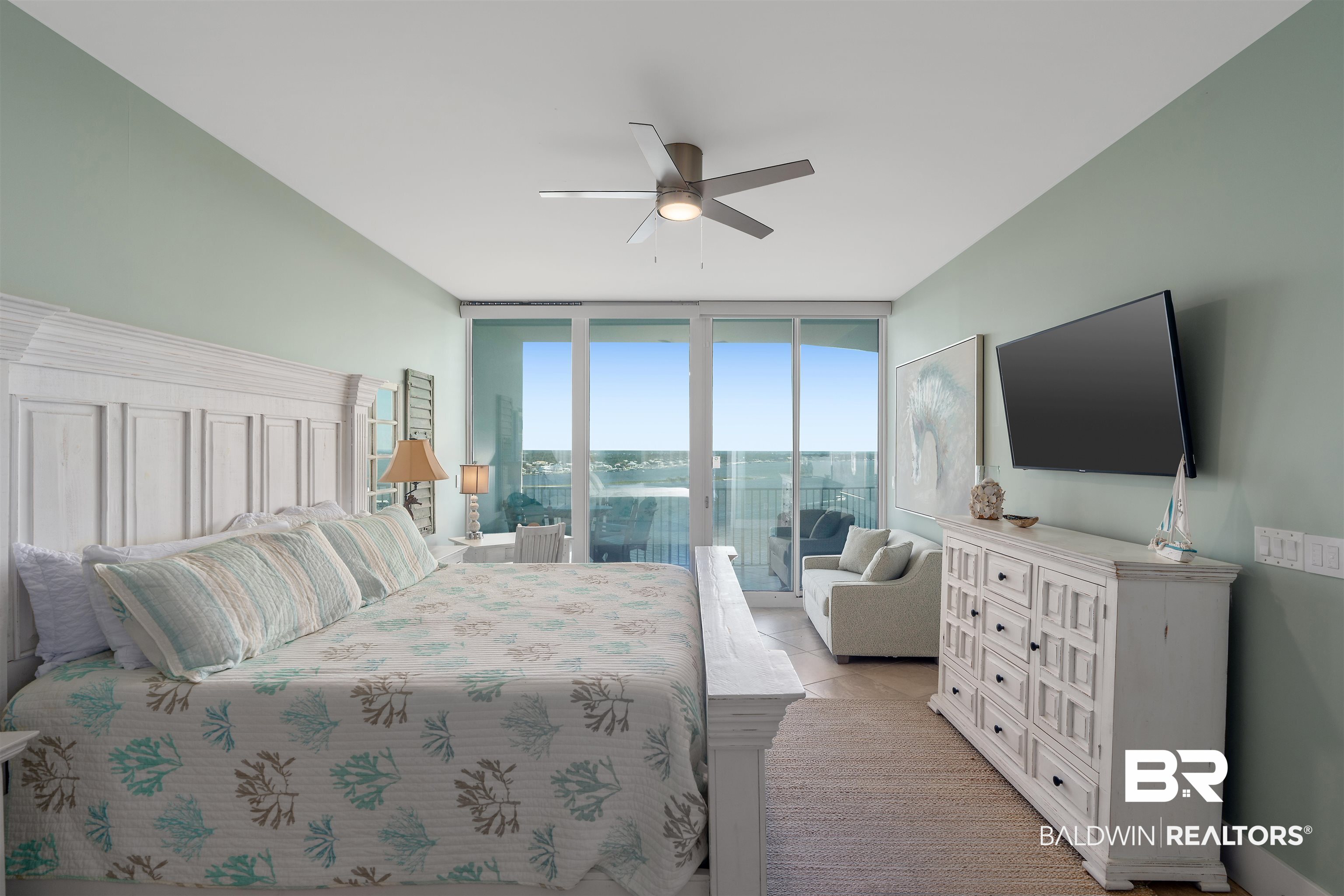 28107 Perdido Beach Boulevard, Unit DPH06 Orange Beach, AL 36561 - Photo 14 of 70 Tiled bedroom with a wall of windows and ceiling fan