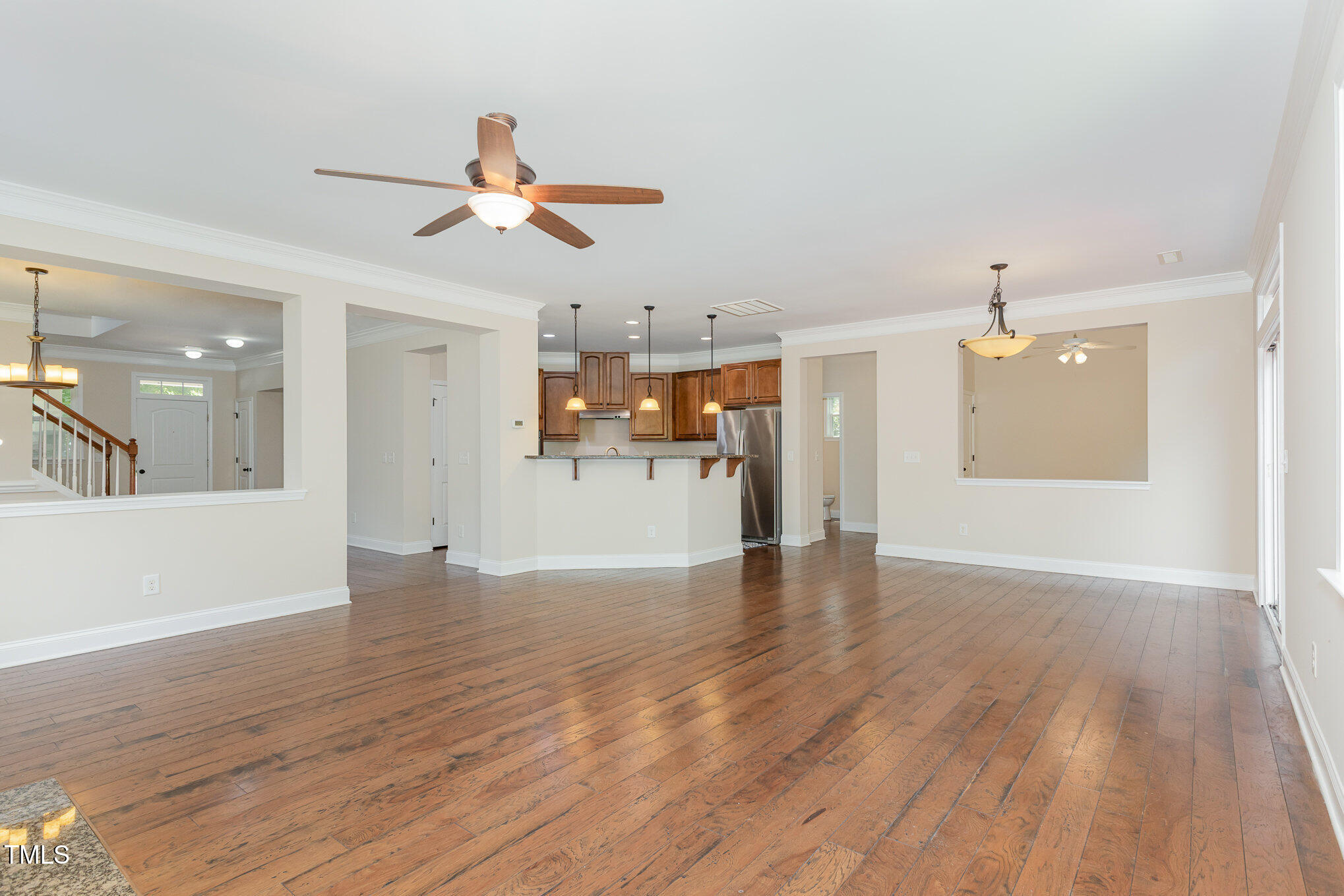1304 Barnford Mill Road Wake Forest, NC 27587 - Photo 10 of 40 a view of empty room with wooden floor and ceiling fan