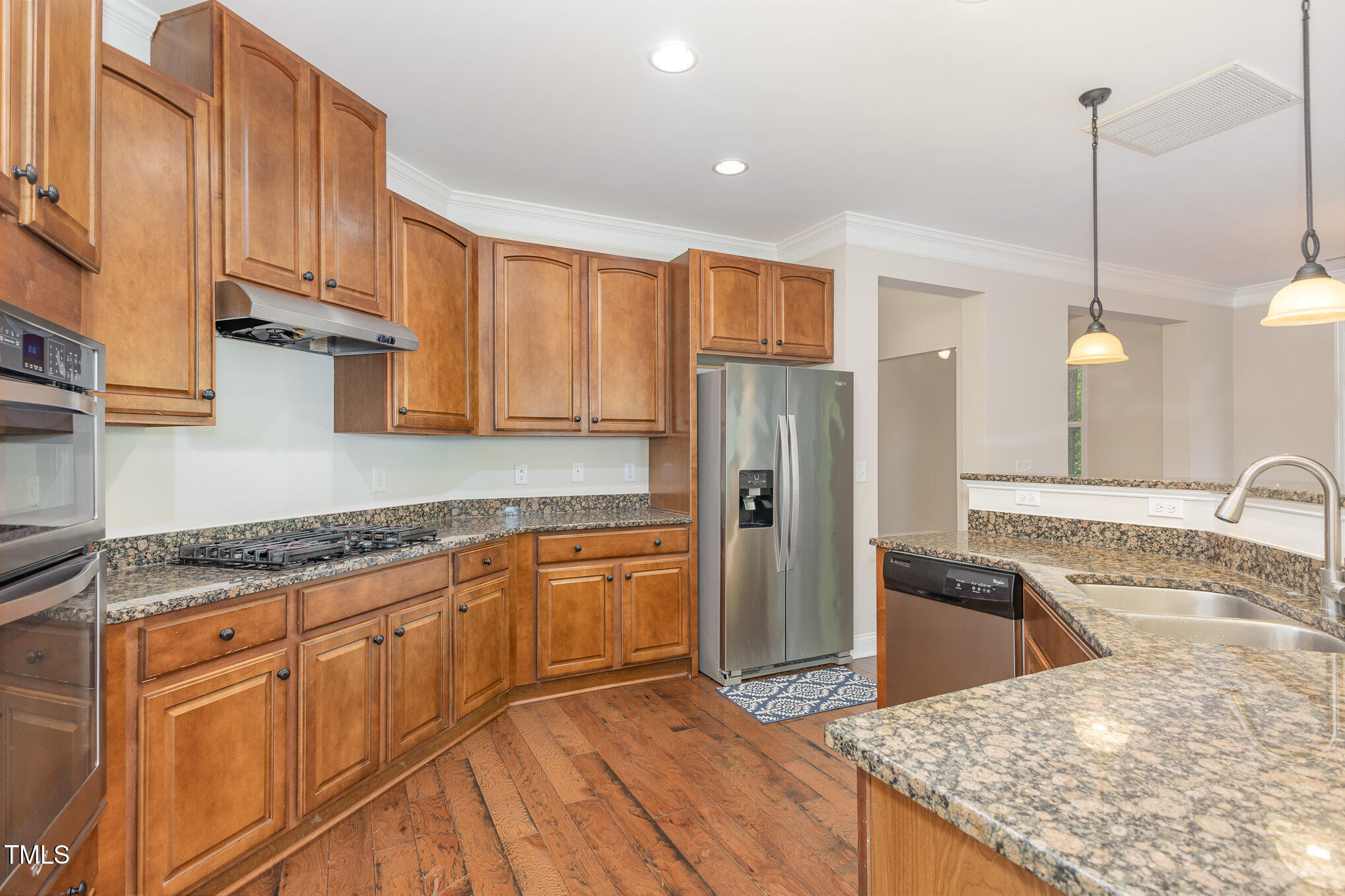 1304 Barnford Mill Road Wake Forest, NC 27587 - Photo 14 of 40 a kitchen with stainless steel appliances granite countertop a sink a stove and a refrigerator