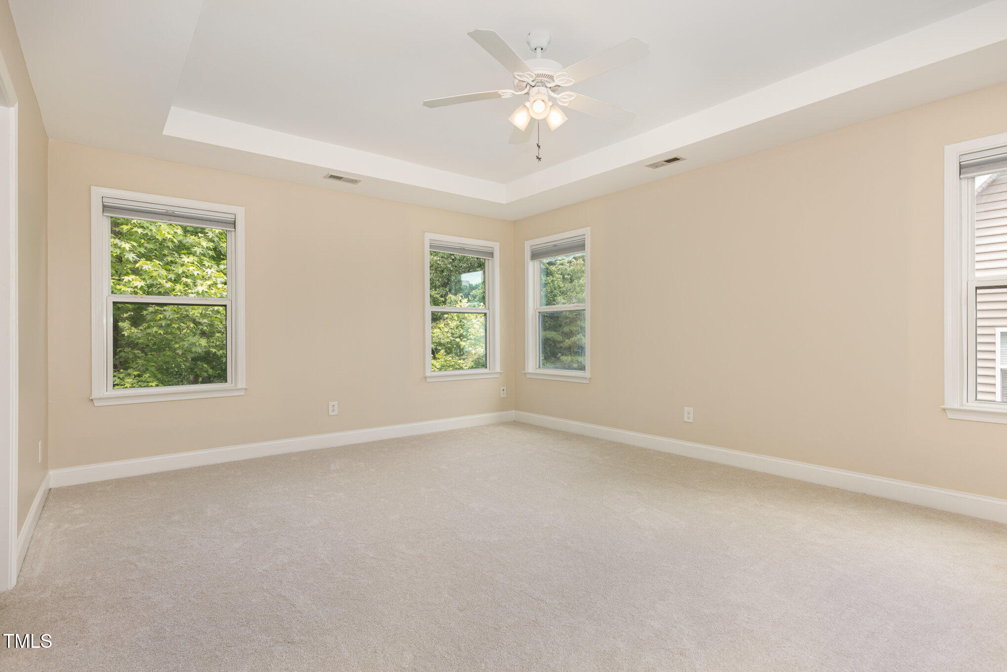 1304 Barnford Mill Road Wake Forest, NC 27587 - Photo 20 of 40 an empty room with windows and chandelier fan